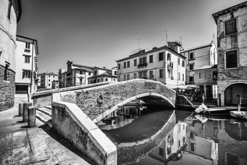 Naklejka premium Typical bridge across a canal in Chioggia, Venice, Italy.