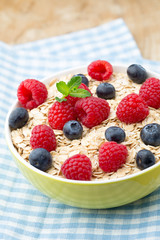 Oatmeal porridge with berries. Raspberries and blueberries.
