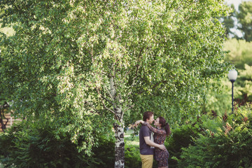 Naklejka na ściany i meble Happy couple in love walking in park