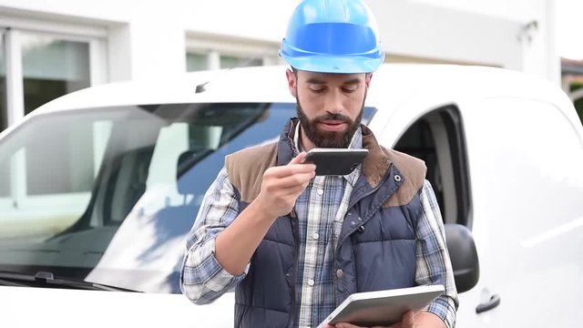 Technician using tablet and answering the phone