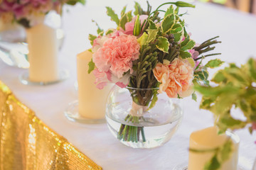 Beautiful table set with candles and flowers for a festive event, party or wedding reception