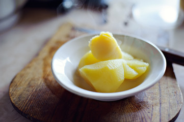 A dish of boiled potatoes on a wooden Board.