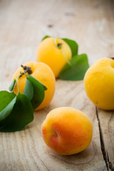 Fresh apricots on the wooden table.