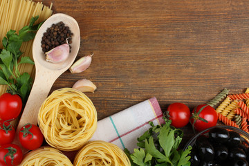 products for cooking pasta on wooden background