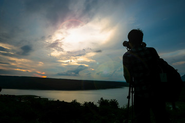 Silhouette of Photographer take a photo on the sunset.