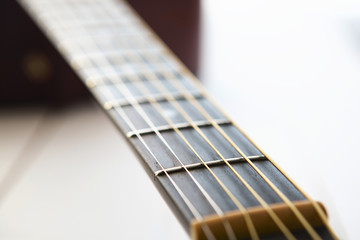 Acoustic guitar on wooden background