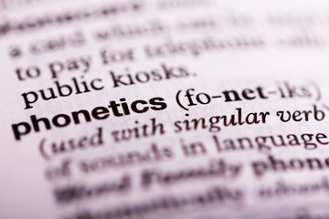 Close up of the dictionary definition of phonetics - obrazy, fototapety, plakaty