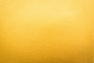 Gold concrete wall on background texture.