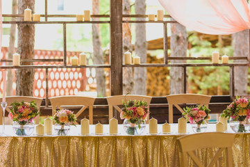 Beautiful table set with candles and flowers for a festive event, party or wedding reception