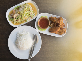 Cucumber salad (Som Tam),Fried chicken wings,cooked rice,food thai style.