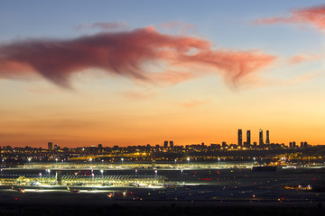 Landscape of the sunset over the city of Madrid, with city lights and clouds
