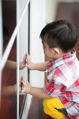 Portrait of little kid learning open the door