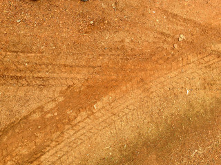 Tire tracks on the road gravel stone background