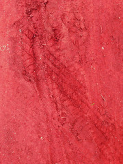 Fototapeta premium Tire tracks on the red road gravel stone background