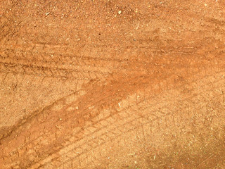 Tire tracks on the road gravel stone background