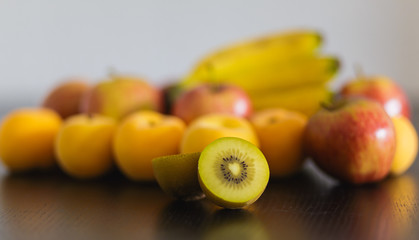 Fruits on a black woody table, symbols of a healthy and fresh diet