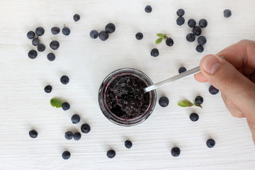  jam tasting of wild berries/ tasting berry jam a small spoon on a background of berries 