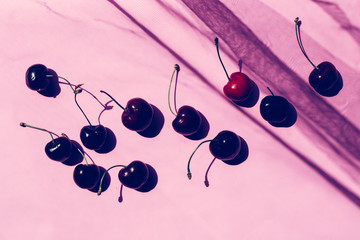 group of cherries on pastel trend background, with spray