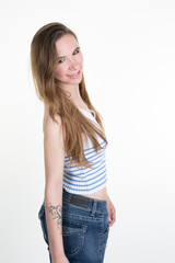 Beautiful blonde teenager in comfortable jeans isolated