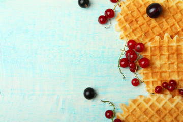 waffles with berries on wooden background