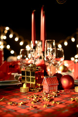 gold and red christmas table decoration with dim light candle