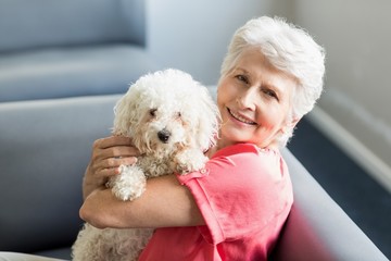 Senior woman holding a dog