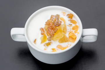 bran  raisin cerea and milk l in a bowl