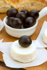 goat cheese with black olives in wood