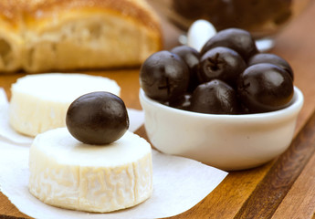 goat cheese with black olives in wood