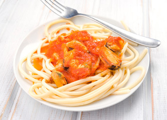 stew homemade spaghetti with prawns and mussels in white dish