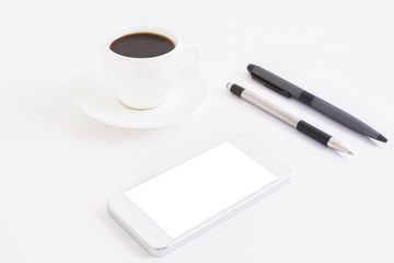Smartphone, coffee and pens