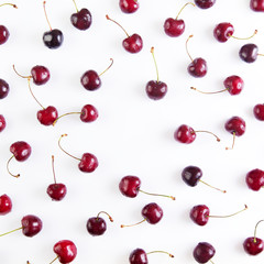 Obraz na płótnie Canvas Colorful pattern of red cherries on a white background. Top view with copyspace