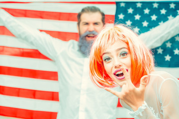 Happy young patriotic Americans bright make up and hair celebrating Independence Day on 4th of July