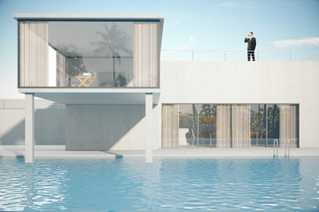 Businessman on roof of house