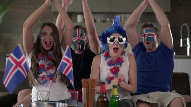 Iceland fans cheers and clapping / four enthusiastic iceland soccer  fans cheering and  clapping hands for Iceland football team

