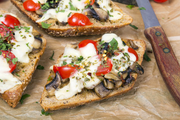 delicious bruschetta with tomatoes, cheese and mushrooms