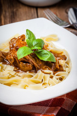 Tagliatelle with dark sauce.