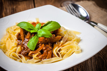 Tagliatelle with dark sauce.