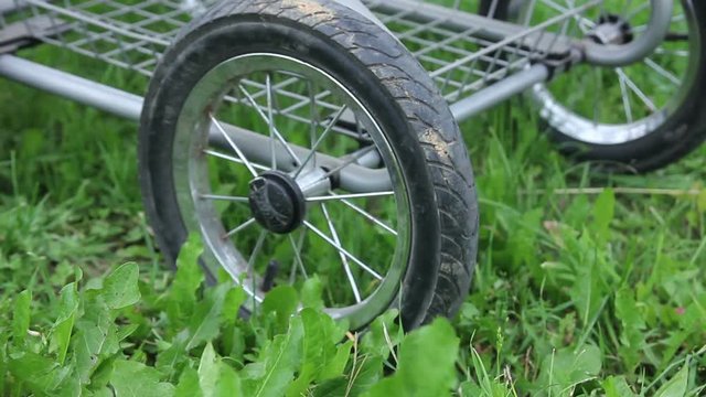 Baby Carriage Wheels Rolling on the Grass