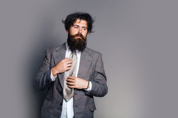bearded man in jacket with tie