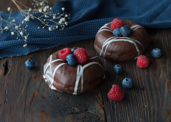 Donuts and berries on a wooden table