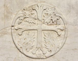 Medieval cross with leaves in Venice, from an ancient sarcophagus on St John and Paul gothic facade, in Venice