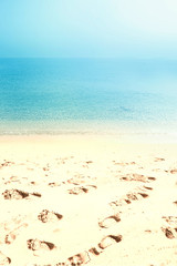 Summer sandy beach with footprints. Sea sand sky and summer day