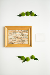 Wooden frame with collage of birch bark and paper.