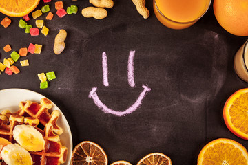 Homemade waffles with orange jam and milk.