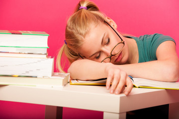 schoolgirl with two hair tails and big eyeglasses sleeping