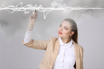 Woman making magic effect - flash lightning. The concept of electricity, high energy.