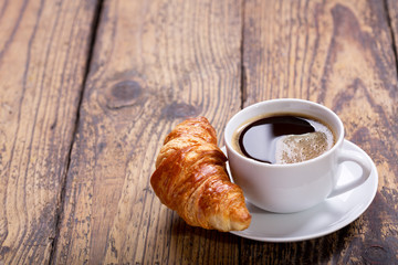 cup of coffee with croissant