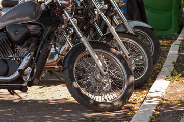 motorcycles in a row the front wheels