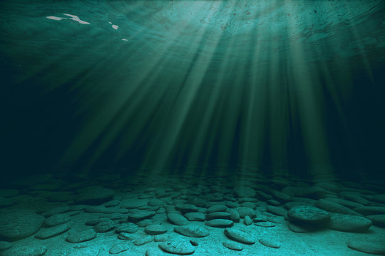 Fototapeta Stones and sunrays under water